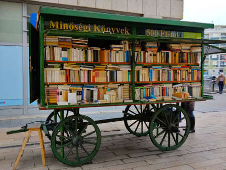 Budapest, Hungary - April 9, 2022: Mobile secondhand bookshop inside a green old-fashioned wagon.のeditorial素材