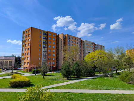Ceske Budejovice, Czech Republic: April 30, 2022 - Orange block of flats with the park in the...
