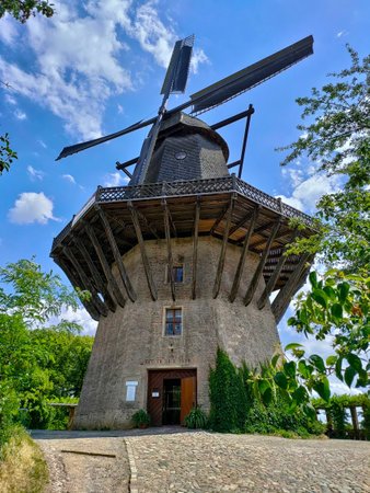 Potsdam, Germany - July 5, 2022: Huge historical windmill in the countryside made of stone and wood.の写真素材