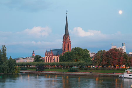 Evening river, embankment and church. Frankfurt am Main, Germanyの写真素材