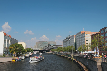 River, cruise motor ships and city. Berlin, Germanyの写真素材