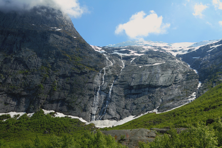 Glacier and falls in mountains. Olden, Norwayの写真素材