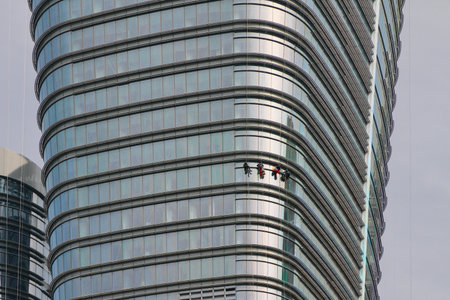 Industrial climbers on facade of high-rise building. Istanbul, Turkey