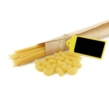 Uncooked of Italian pasta and spaghetti wrapped in brown paper with wooden tag isolated on a white background.の写真素材