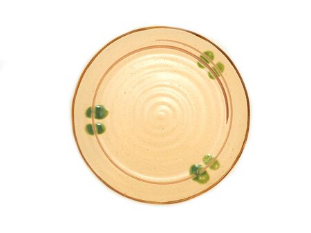 Empty circle ceramic plate with a brown rim and green pattern isolated on a white background. Used for serving, View from abvoe.の写真素材
