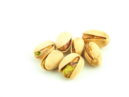 A pile of pistachios isolated on a white background. Close up, High Vitamin B6 and antioxidants. Low in calories yet high in protein.の写真素材