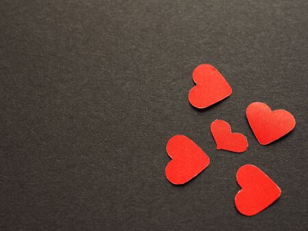 Red paper heart shape on black background of your text. The concept for design, wallpaper, love. Top view.の写真素材