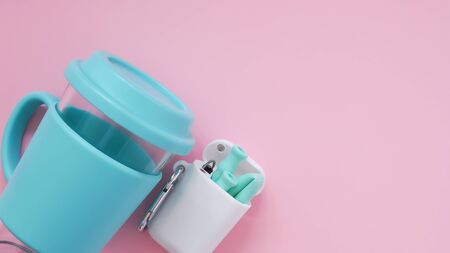 Reusable cyan silicone drinking straws and a cleaning brush in the white box with a hanger, glass on pink background, from upper view, eco-friendly lifestyle. Zero waste concept.の写真素材