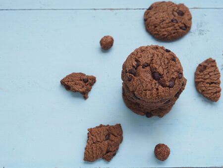 Stack homemade double chocolate chip cookies on blue wooden background. View from above, copy space.の写真素材
