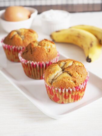 Close up healthy homemade banana cake in white plated on white fabric background.の写真素材