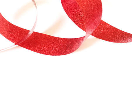 Red ribbon, spiral coil On white paper background with copy space.