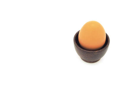 Fresh egg in wooden brown bowl isolated on a white background. High protein.の写真素材