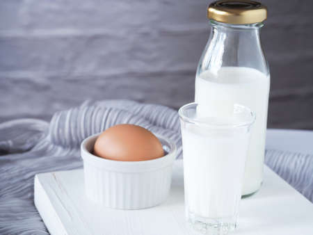 Fresh dairy products on white wooden and have a backdrop in grey fabric.の写真素材
