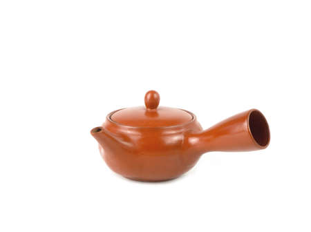Brown clay teapot isolated on a white background. Asian food concept, space for text.の写真素材