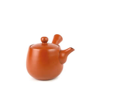 Brown clay teapot isolated on a white background. Asian food concept, space for text.の写真素材