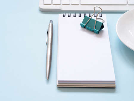 Close up blank notebook with offfice supplies on blue workplace desk table. Business and education...