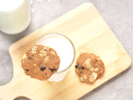Healthy homemade oat cookies put on glass milk over wooden plate. Top view with copy space.の写真素材