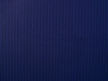 Empty dark blue colored corrugated background texture. The concept for image, text, design.
