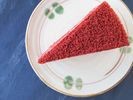 Top view piece of red velvet cake in soft brown plate on black stone background. Copy space for your text.の写真素材