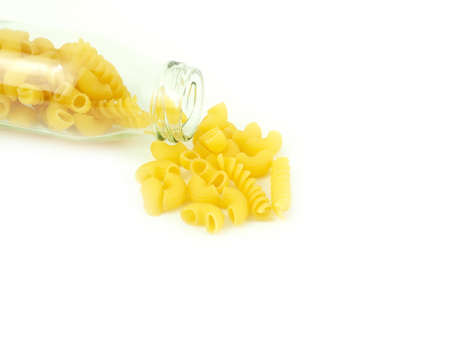 Raw italian pasta heap with glass bottle isolated on a white background. Cooking concept.
