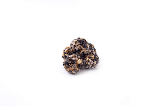 Pile of black sesame and almond cereal ball isolated on a white background.の写真素材