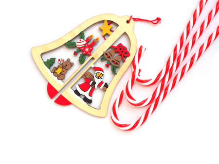 Wooden hanging bell and candy cane for christmas decorations isolated on white background.の写真素材