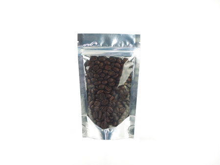 Coffee beans in aluminum foil transparent window bag, with zipper isolated on a white background.の写真素材