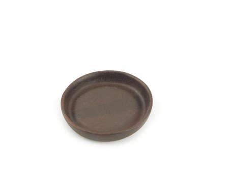 Empty brown old clay saucers, for food use home or restaurant isolated on a white background. Kitchen accessory.の写真素材