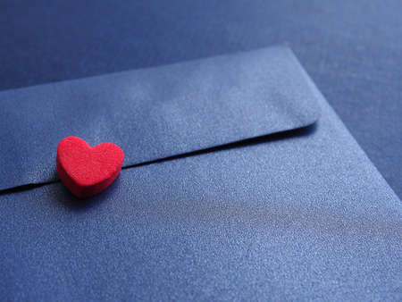 Red hearts on elegant blue paper envelopes background. Concept of love and encouragement.の写真素材