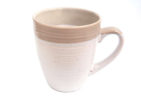 The empty beige color of coffee or tea mug isolated on a white background. Drink design concepts.の写真素材