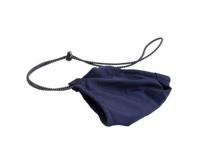 Reusable dark blue fabric face mask with adjustable ear loop and neck isolated on a white background. Concept of  outbreak and pollution. New normalの写真素材