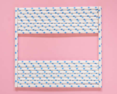 Star-shaped paper tube frame on pink background, top view and copy space.の写真素材