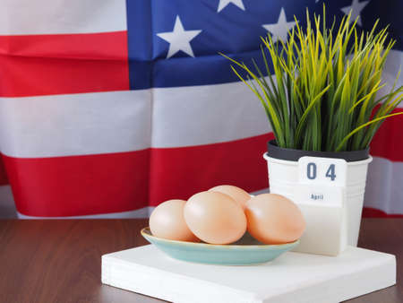Easter eggs in turquoise plate and calendars, decorative trees with a backdrop of the American flag...