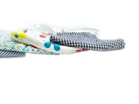 A pile of multi colored of fabric face mask isolated on a white background. Concept of coronavirus...