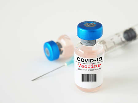 Close up, vaccine vial and syringe on white background, with copy space. Concept of virus outbreak.の写真素材