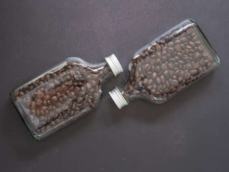 Top view, flat lay roasted coffee beans in glass bottle on drak grey background, space for your text.の写真素材