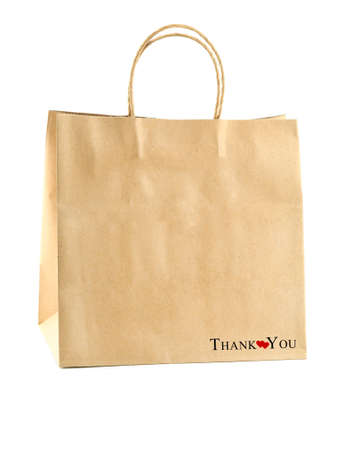 Brown kraft paper bag with the word "Thank you" and small red heart for takeaway food, merchandise, isolated on a white background. Eco-friendly, reusable, Zero waste concept.の写真素材