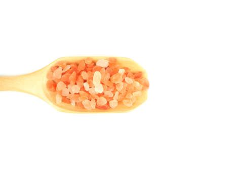 Flat lay, Top view, of himalayan pink salt in wooden scoop isolated on a white background.の写真素材