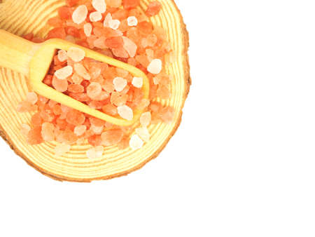 Flat lay, Top view, of himalayan pink salt in scoop over wooden isolated on a white background.の写真素材