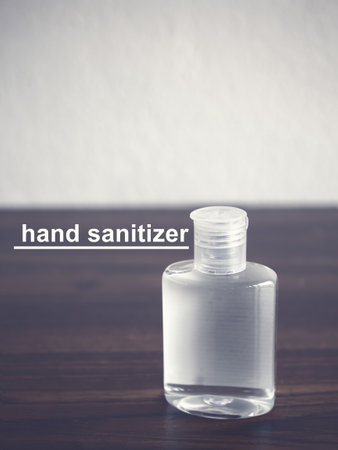 Hand sanitizer alcohol gel on brown wooden table. Concept of coronavirus outbreak and pollution. New normal.の写真素材