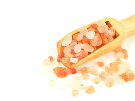 Himalayan pink salt in wooden scoop isolated on a white background. Close up with copy space for your text.の写真素材