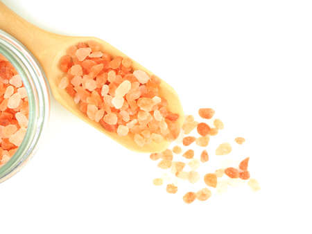Top view, Himalayan pink salt in wooden scoop with glass bottle isolated on a white background.の写真素材