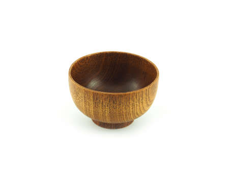 Empty wooden bowl isolated on a white background. Used serving for home or restaurant, food design. Kitchen accessory.の写真素材