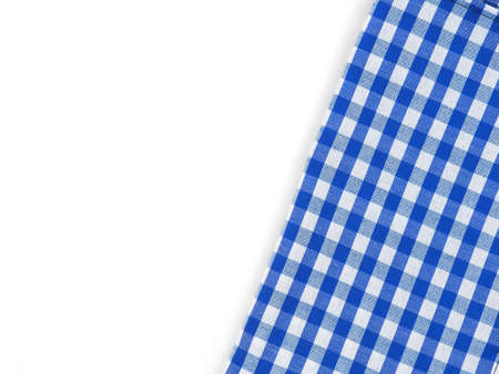 Top view, close-up of blue and white checkered fabric or napkin on white table background. Concept kitchen utensils and tableware. Top view, flat lay with copy space.の写真素材