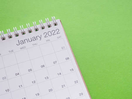 Month page of January 2022 calendar on green paper background. Close up, space for your text.の写真素材