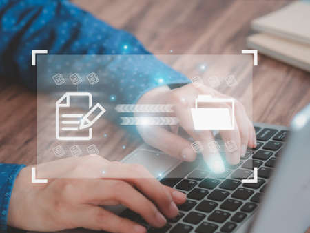 Businessmen use a laptop to transfer, backup, and download documents online. Receive - send, and exchange databases, Data transfer concept.の写真素材