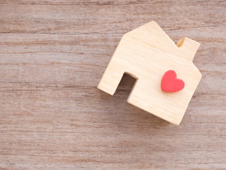 Top view house wooden toy with red heart on a rustic table. Home sweet home. Concept finance, insurance, lone.の写真素材