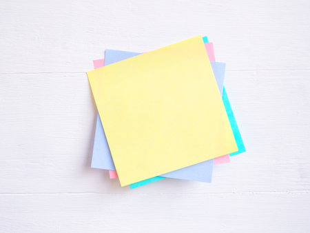 Sticky note ( Post-it) stack on a white wooden. Blank space for text and template for your message.の写真素材