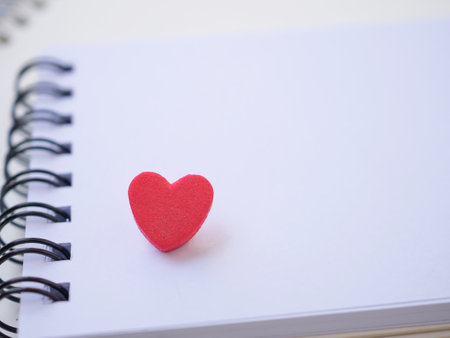 Close up, red heart on spiral notepad with copy space for your text and design.の写真素材