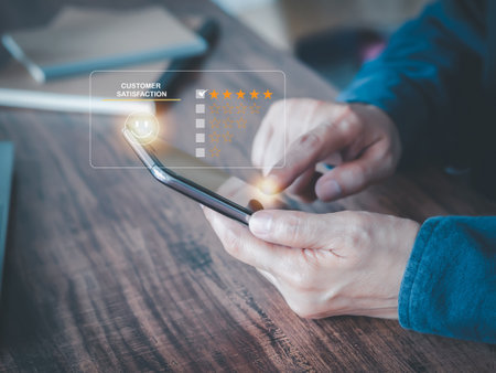Customer touching the virtual screen on the happy smiley face icon sends feedback to service experience online smartphone applications. Customer service and Satisfaction Rating Concept.の写真素材